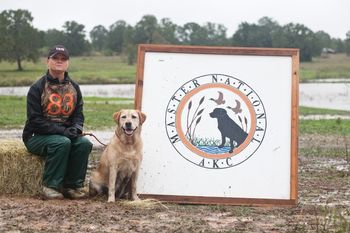 2009 MASTER NATIONALS IN GIDDINGS, TX "ROXY" After you run the first series at the Master National you go by the photo tent for your official MN photograph. The day before this picture was taken this area looked a lot different. A monsoon came the night before and the lake you see behind the MN sign was mostly land. Angie was as wet as Roxy........and this was a land series. You have to play with the cards you are dealt so my tip after all this is: Train in the rain on occasion, the dogs do react differently in adverse weather conditions.
