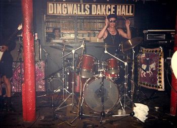 Dingwalls, UK, 1988 Problems solved! Ned is back in action! Sound man in little booth behind him looks on. Job well done! Photo by Steve Power
