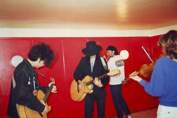 Oslo, Norway, 1988 Sardines dressing room. Marc and Andy play while Chas keeps time. Guest violinist, Laurie Kempen follows along. Photo by Gail Holland

