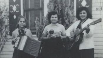 Eva (Accordion), childhood friend Raquel Escobar (Maracas), and Lily Ybarra (Bajo Sexto) posing outside of Raquel’s home. L – R: Eva Ybarra, Raquel Escobar, Lily Ybarra.
