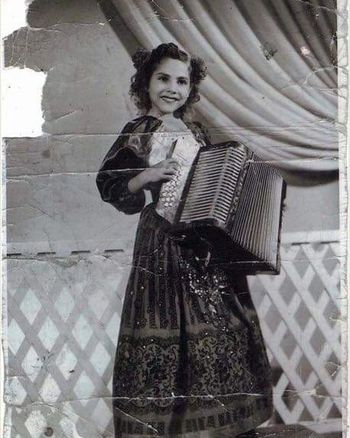 Ybarra posing for a promotional photo in a china poblana dress sewn by her grandmother, Josefa Gonzales Araiza. The dress was made specifically for her appearance on KWEX, the local San Antonio Univision station. Eva was approximately seven years old.
