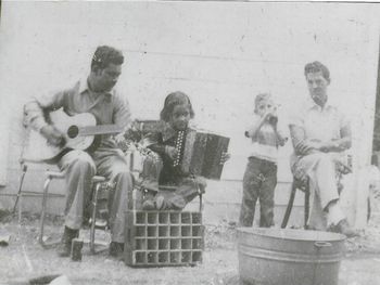 (Close-up) Local musician, Rudy Jímenez (Guitar), accompanying Eva (Accordion) outside a San Antonio icehouse. L – R: Rudy Jímenez and Eva Ybarra
