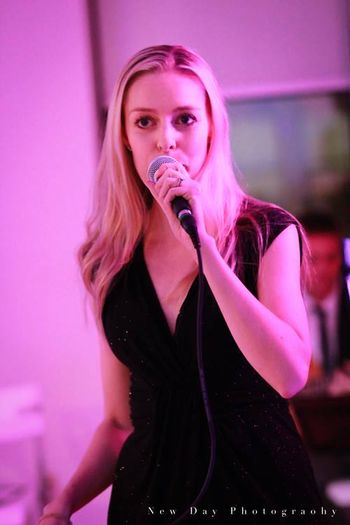 Performing a vocal jazz set at a holiday party
