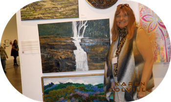 Karen Colville with art VOAF  art wall display.
