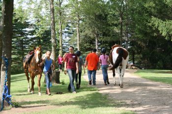 The kids practice leading a horse correctly and safely.

