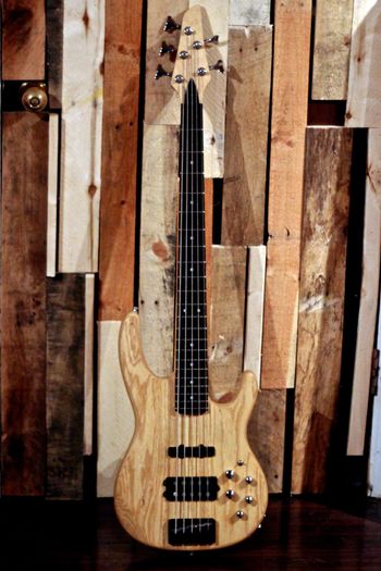 (05/06/14) This is a 5 string bass I put together from a Carvin Kit. The body is Swamp Ash and the neck is Maple with an Ebony fretboard. I did just an oil finish on the whole bass. It is a very resonate instrument and also surprisingly light as well. It has active electronics with a J pickup in the neck and a Humbucker in the bridge, both pickups are Carvin. I put this bass together years ago so I had a 5 string to write parts on and it has stood the test of time and is still a great bass.
