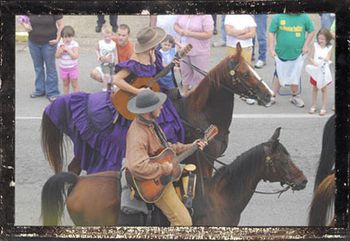 Mean Mary (Mary James) & Frank James presenting horseback music in parade
