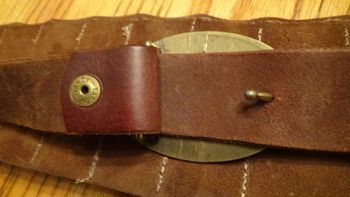 just like a belt (includes a real belt buckle) the straps come together easily
