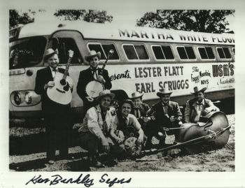 Flatt & Scruggs standing in front of their Flxible Tour Bus.
