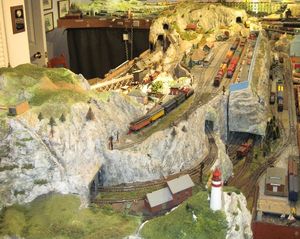 The "Mountain Module" as part of the layout today.  The original control panel (now removed) and the three exchange tracks have been covered over by a (removable tunnel) that sports a scenic backdrop to the station on the upper level.  