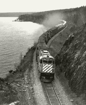 A container train wends its way along Moosehead Lake at Bald Bluff in Maine. George S. Pitarys photo.