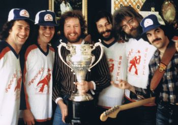 An early version of MONDO COMBO posing with the Allan Cup in 1979. The Squire Hotel in Petrolia, where we were playing, sponsored the hockey team.

