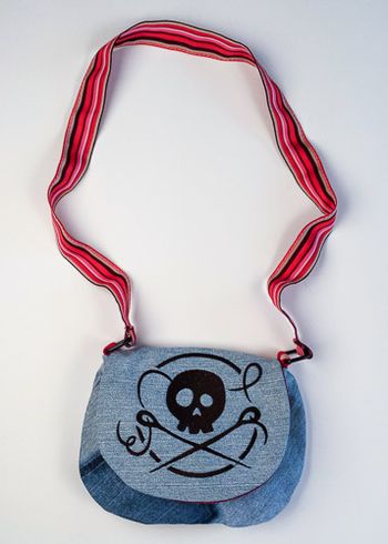 Skull and Needles embroidered on upcycled denim. The strap is a belt.
