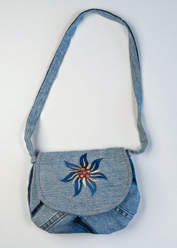 Flower embroidered on upcycled denim. The strap is denim also.
