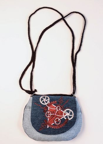 Steampunk Alchemy Clockwork embroidered on upcycled denim. The strap is a belt.
