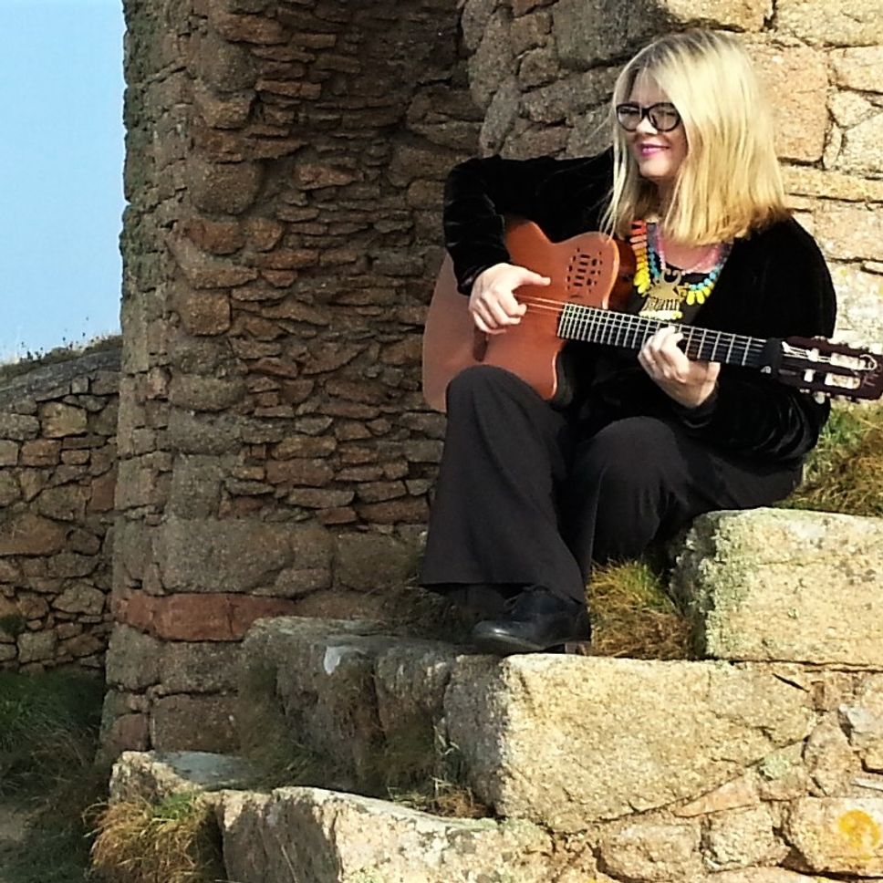 solo guitarist playing at Grosnez Castle, Jersey