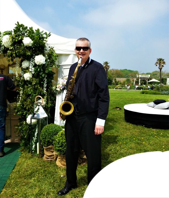 saxophone musician at outdoor wedding booking