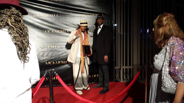 Sphere TU & DJ Trouble Enuff posing for photo on Red carpet at Akademia awards event.