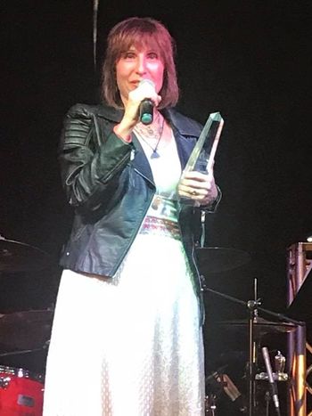 Patricia Bahia accepting her 2018 Positive  Music Awards
