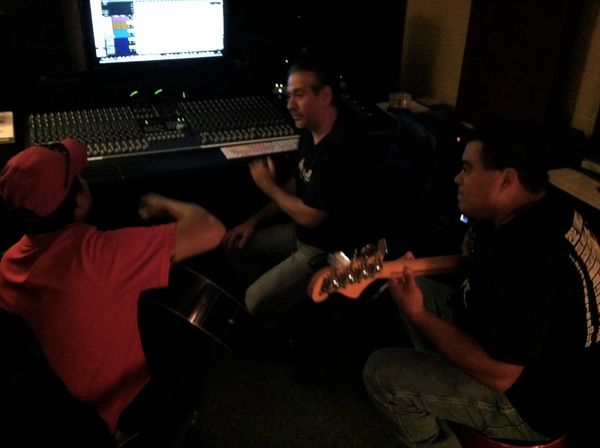 Erikk Lee (center) discusses musical arrangements with Richard Villarreal, Jr. (left) of the Anna Roman band and Jorge Arreola of the multi-Grammy Award winning Los Palominos (right).