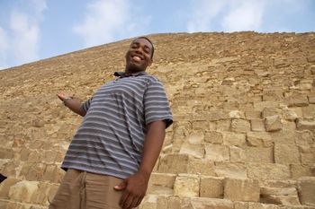 Standing in front of the Pyramid of Khufu in Giza, Cairo, Egypt
