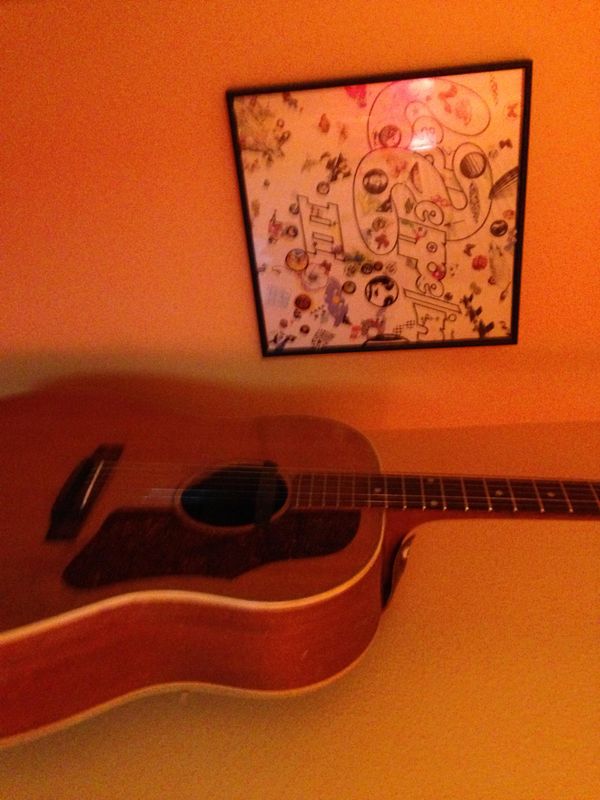 1958 Gibson J-50.  This is the guitar I picked up at age 11 and learned to play.  With Dad's help, of course.  I usually leave it in open D tuning, thus the Led Zep III on the wall for companionship. 