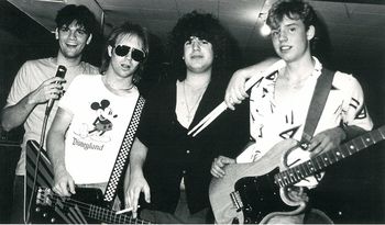 Lance (second from left) and Scott Proce (long-haired smoker). Their first band: GO AWAY. Circa 1985.
