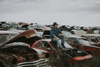 Jon Young hanging out on an old car at FM600 Wrecking in Abilene, Texas.  Photo by Zach Weber Photography.
