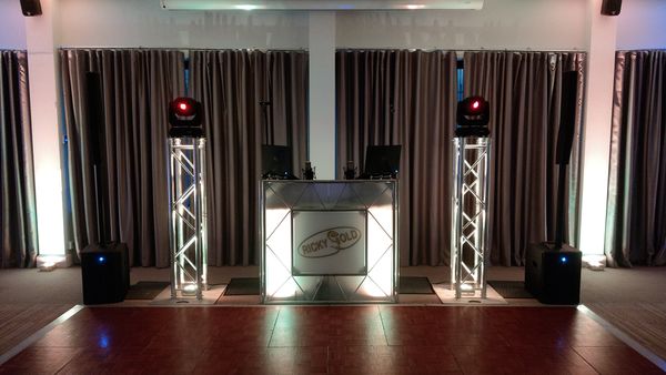 DJ Ricky Gold DJing a Wedding at the RNLI College, Poole. Pure Elegance with large 1.5m Podiums and uplighting.