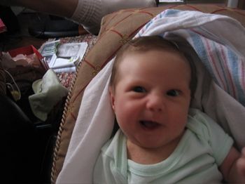 One of Daisy's early crooked smiles. Now her smiles are straight, but she has these great big teeth -- seriously, as big as corn nuts -- so it's still a little goofy. So cute though.
