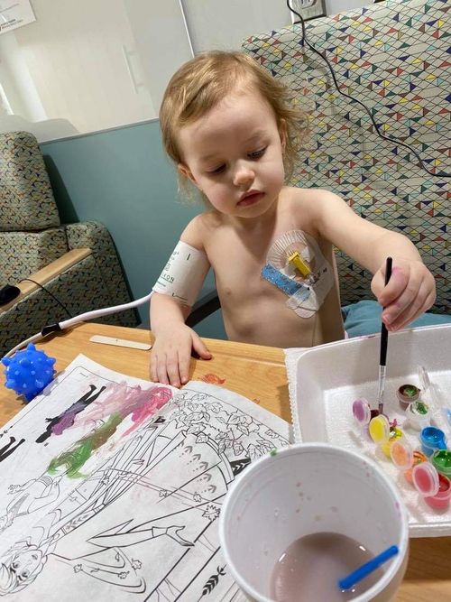 Paislee Painting while she gets chemo at the hospital.