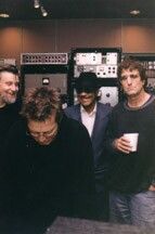 PAUL OSCHER, HUBERT SUMLIN AND DAVE MAXWELL WITH ERIC CLAPTON IN THE FOREGROUND LISTENING TO PLAYBACKS AT THE STUDIO.
