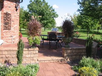 paver patio with seat wall a seat wall is a free standing wall that can be used to sit on or as a court yard type wall A seat wall brings a level of intimacy when surrounding the patio
