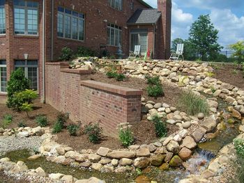 This water feature has a pond at the top with a 70' stream at the lower end it is "pondless" it will only become more beautiful as the plantings grow
