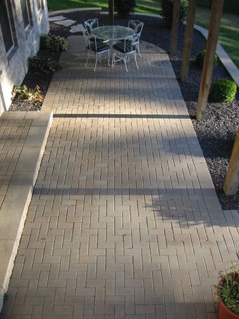 This patio and retaining wall was built when the home was newly constructed Then a few years later a lower patio with fire pit and a lower basket ball court were installed Buckleys prides itself on creating a useful beautiful areas out of hard to negotiate terrains
