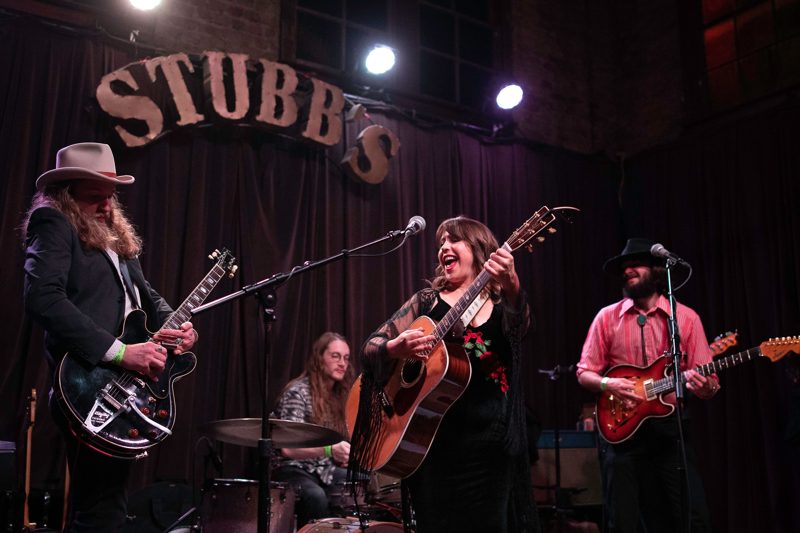 Jenna Watters smiling, looks on as Nick Boettcher sits in with the Watters band