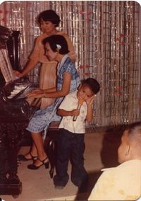 Antoine with Grandma (Lola), Gloria Reynaldo on piano and Mom, Luna Reynaldo Diel turning pages.