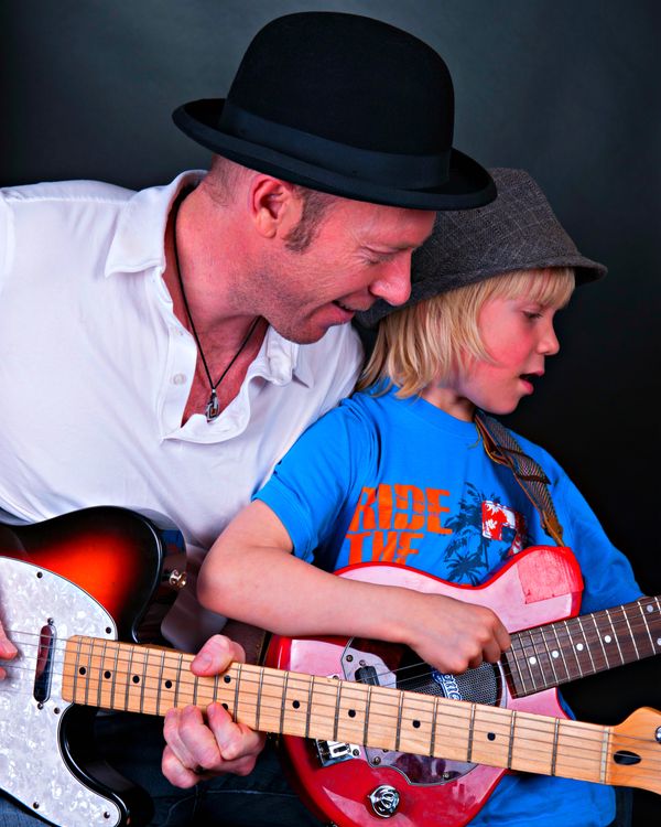 Greg enjoys a jam with his son Parker.
