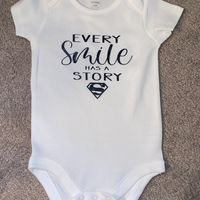 Every Smile has a Story Superman Onesie