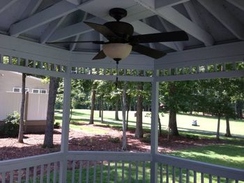 Screened Gazebo with electric and ceiling fan.
