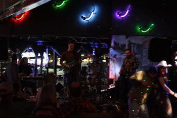 Colored lizards, pretty spots of light, a cowboy hat and a man stalking the steel with the L-Town Allstars @ Sweetwater Station, Westminster, CO, 2-11-2011. Photo by Kip Martin.
