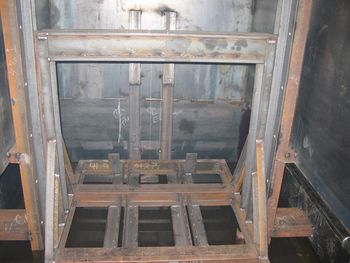 Computer controlled elevator (Inside Quench Tank) for lowering and raising parts
