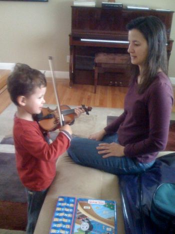 My sister Lisa torturing my nephew Tanor with the violin
