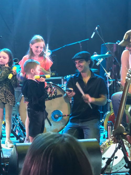 Poche Ponce accompanying some youngsters who were invited on stage for their evening concert at Veteran's Park in Manchester, NH - August 22, 2019