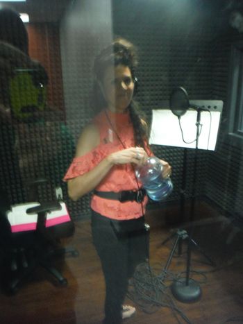 Amy C. Smith at DiCarlo Productions taking a break to drink water.  Drinking water between songs helps to lubricate the vocal chords, and not strain one's voice.
