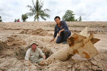Laith Stevens & Linthong Syphavong with bomb left from the "Secret War" over 40 years ago
