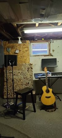 The studio so far... 1 cork board in pic, SM7B, foam vocal pad, breed love guitar, and a Roland Piano