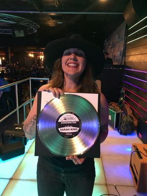 Americana singer/songwriter Sarah King holding New England Music Awards Songwriter of the Year 2021 award