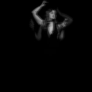 Black and white blurred photo of singer/songwriter Sarah King