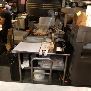 cheesesteaks in progress on the flat top